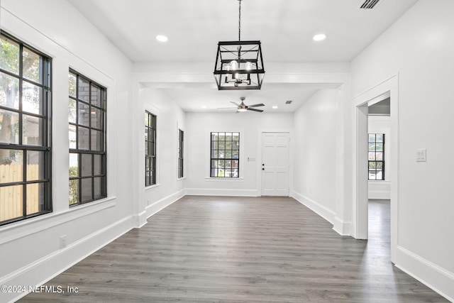 unfurnished dining area with a wealth of natural light and dark hardwood / wood-style flooring