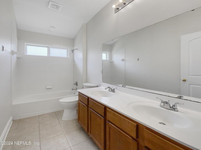 full bathroom with double sink vanity, shower / tub combination, tile patterned flooring, and toilet