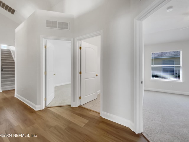 hallway with light hardwood / wood-style floors