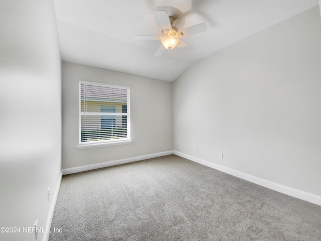 carpeted empty room featuring ceiling fan and vaulted ceiling