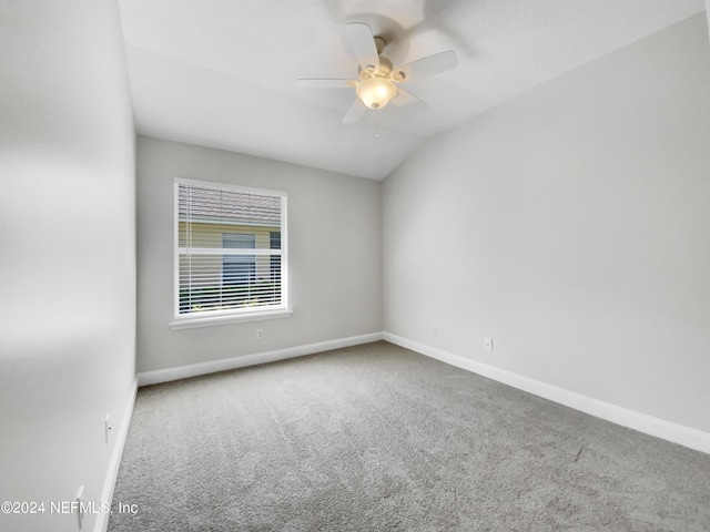 spare room featuring vaulted ceiling, ceiling fan, and carpet floors