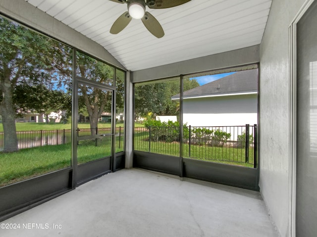 unfurnished sunroom with ceiling fan