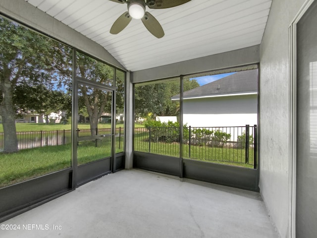 unfurnished sunroom with a water view, plenty of natural light, ceiling fan, and lofted ceiling