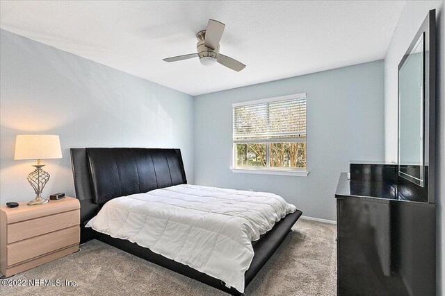 bedroom with ceiling fan and carpet