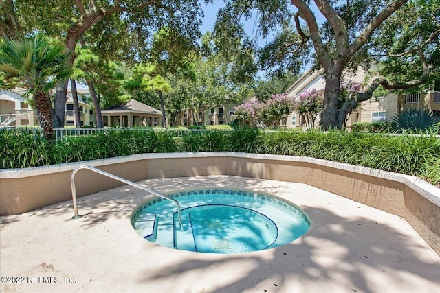 view of pool with a community hot tub