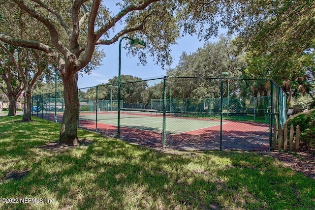 view of sport court featuring a yard