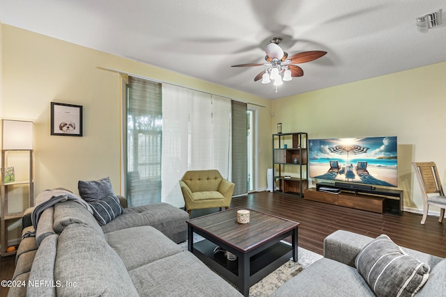 living room featuring a textured ceiling, ceiling fan, and hardwood / wood-style flooring