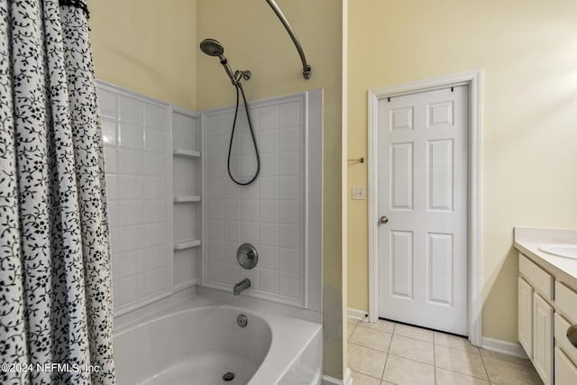 bathroom with tile patterned flooring, shower / bath combo with shower curtain, and vanity