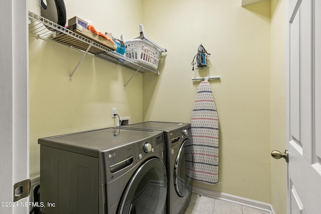 washroom featuring separate washer and dryer and light tile patterned floors