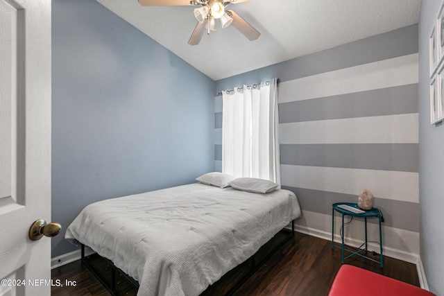 bedroom with ceiling fan, vaulted ceiling, and wood-type flooring