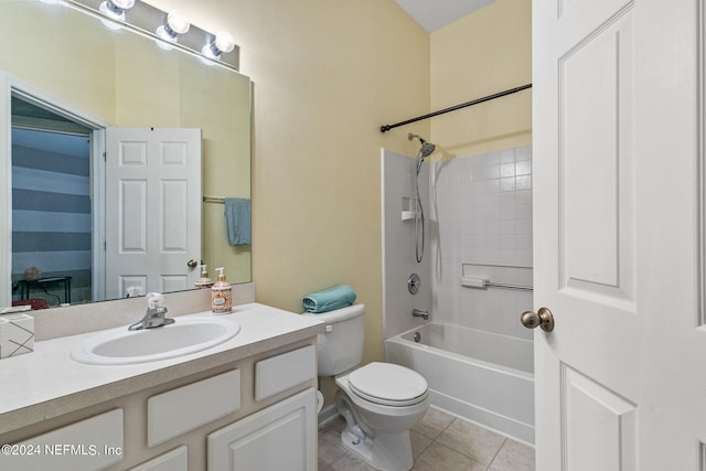 full bathroom with tiled shower / bath combo, tile patterned flooring, toilet, and vanity