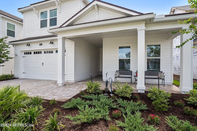 view of front of house featuring a garage and a porch