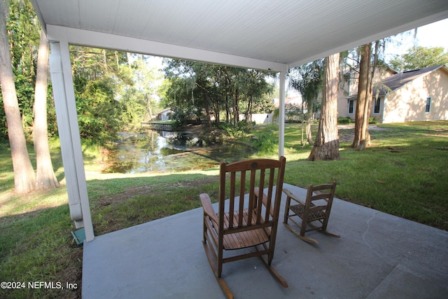 view of patio with a water view