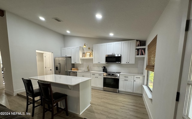 kitchen with stainless steel appliances, visible vents, vaulted ceiling, decorative backsplash, and open shelves