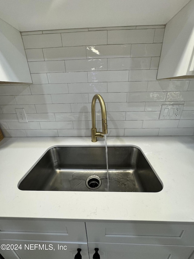 interior details with tasteful backsplash and a sink