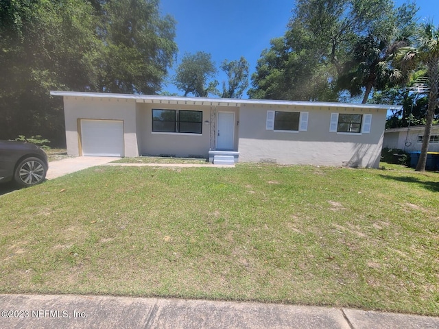 view of front of property with a garage and a front yard