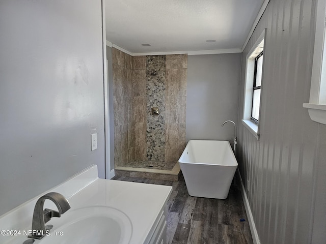 full bath featuring a freestanding bath, wood finished floors, vanity, and a tile shower