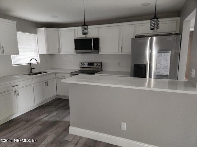 kitchen with stainless steel appliances, decorative backsplash, wood-type flooring, sink, and decorative light fixtures