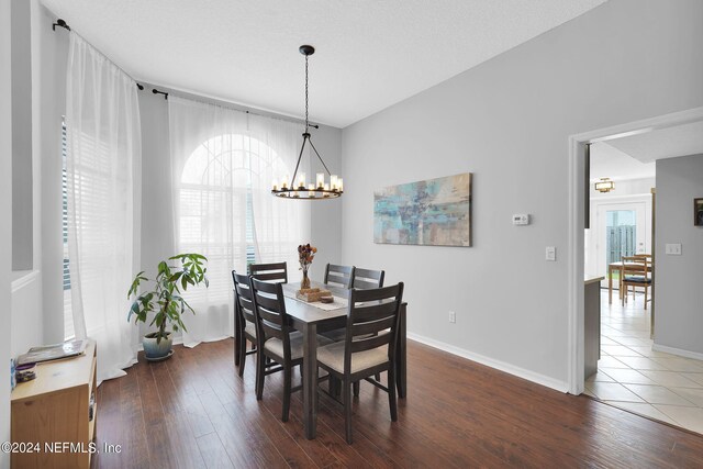 dining space with a chandelier and hardwood / wood-style flooring