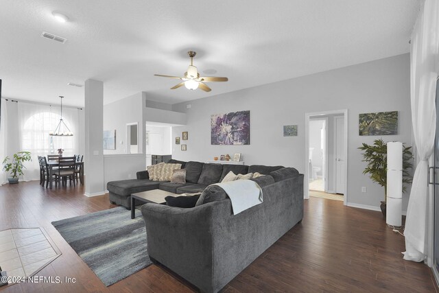 living room featuring ceiling fan and dark hardwood / wood-style floors