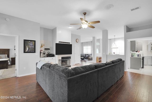 living room with ceiling fan and hardwood / wood-style flooring