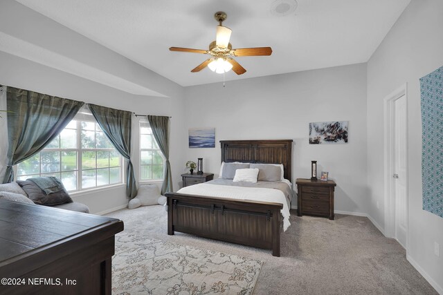 bedroom featuring light carpet and ceiling fan