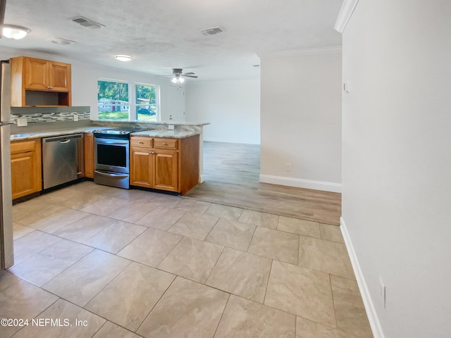 kitchen featuring brown cabinetry, visible vents, stainless steel appliances, and light countertops