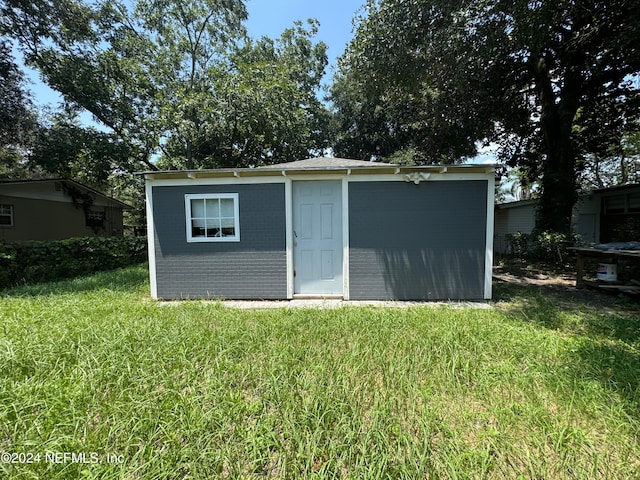 view of outdoor structure featuring a lawn