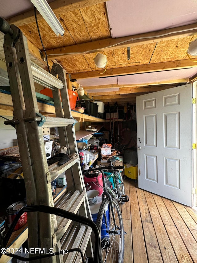 basement with hardwood / wood-style floors