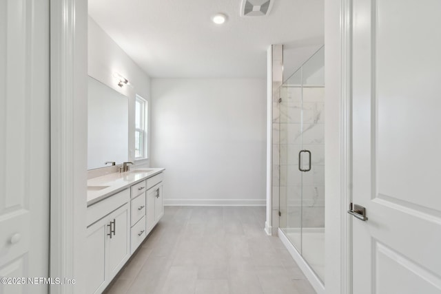 bathroom with a shower with door and vanity