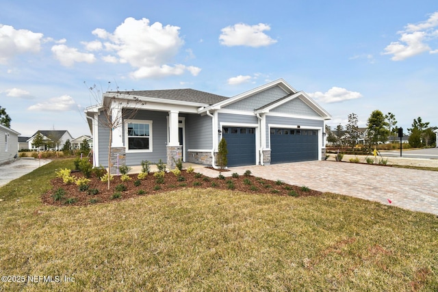 craftsman-style house featuring a garage and a front lawn