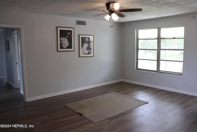 3037 Ribault Scenic Dr, Jacksonville, FL 32208 - empty room with dark wood-style floors, visible vents, a textured ceiling, and a ceiling fan