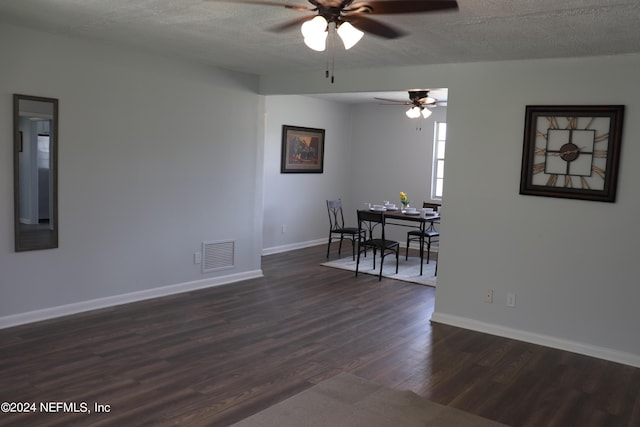 3037 Ribault Scenic Dr, Jacksonville, FL 32208 - dining room with baseboards, dark wood finished floors, a textured ceiling, visible vents, and a ceiling fan