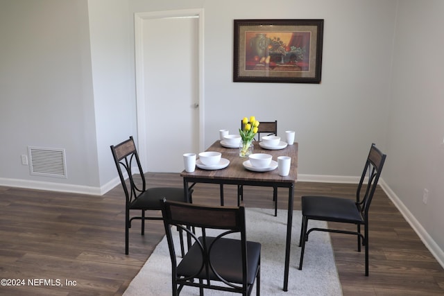 3037 Ribault Scenic Dr, Jacksonville, FL 32208 - dining area with baseboards, visible vents, and dark wood-type flooring