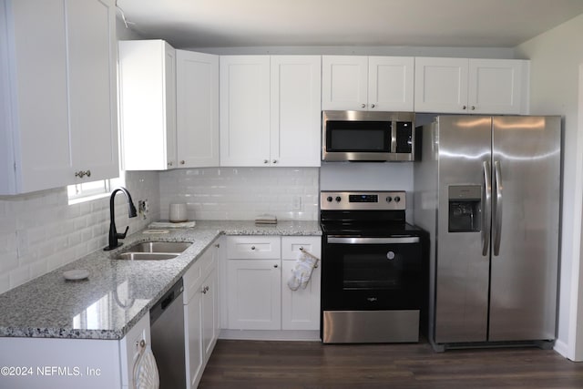3037 Ribault Scenic Dr, Jacksonville, FL 32208 - kitchen with a sink, light stone countertops, appliances with stainless steel finishes, white cabinets, and dark wood-style flooring