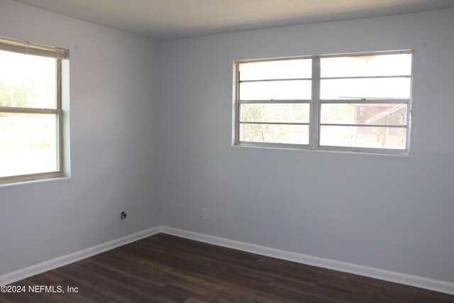 3037 Ribault Scenic Dr, Jacksonville, FL 32208 - empty room with baseboards, a wealth of natural light, and dark wood-style flooring