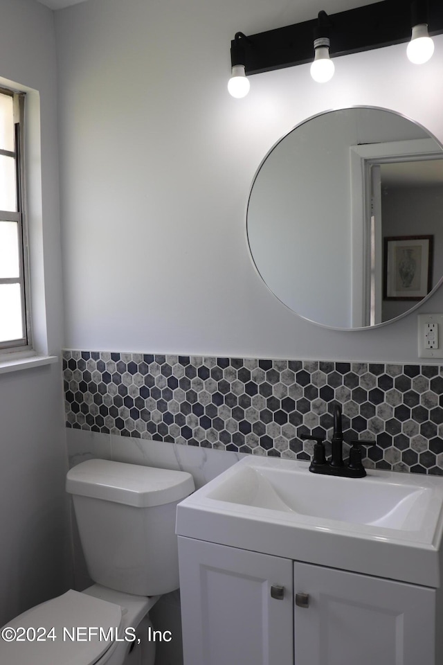 3037 Ribault Scenic Dr, Jacksonville, FL 32208 - half bath featuring toilet, vanity, and wainscoting