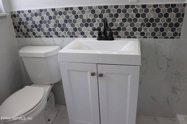 3037 Ribault Scenic Dr, Jacksonville, FL 32208 - bathroom with marble finish floor, vanity, toilet, and tile walls