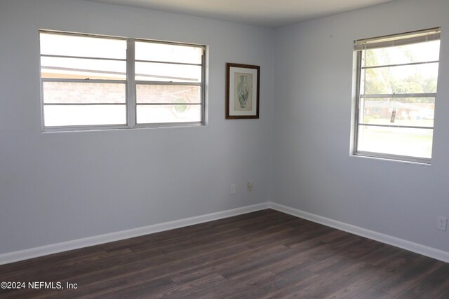 3037 Ribault Scenic Dr, Jacksonville, FL 32208 - spare room with dark wood-style floors, baseboards, and a healthy amount of sunlight