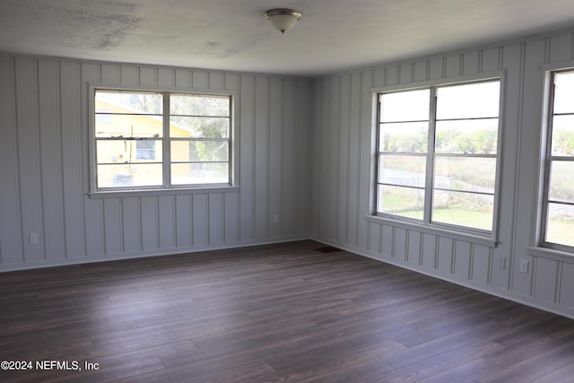 3037 Ribault Scenic Dr, Jacksonville, FL 32208 - empty room with dark wood-style flooring, visible vents, and a healthy amount of sunlight