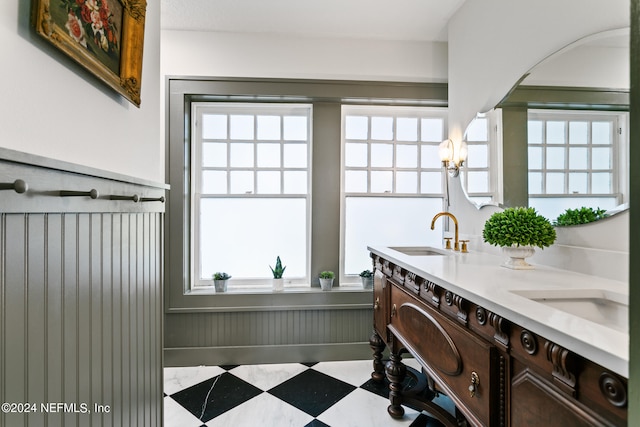 bathroom with tile patterned floors, double vanity, and plenty of natural light