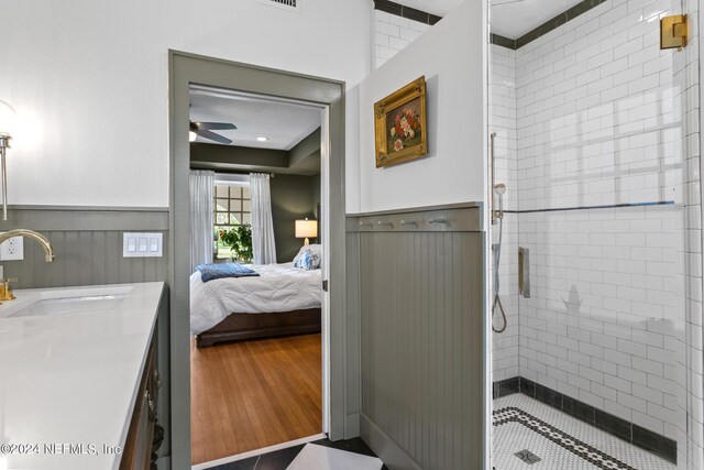 bathroom with an enclosed shower, vanity, ceiling fan, and hardwood / wood-style floors