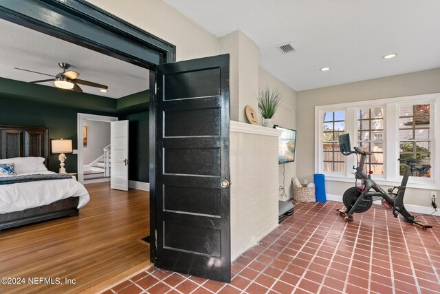 interior space with ceiling fan and wood-type flooring