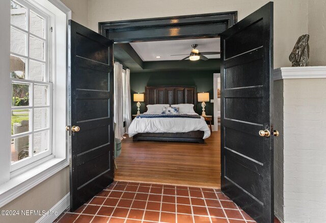 bedroom with dark hardwood / wood-style floors and ceiling fan