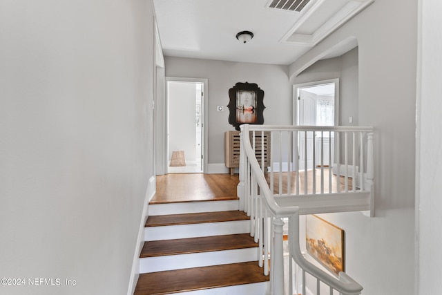 stairs featuring wood-type flooring