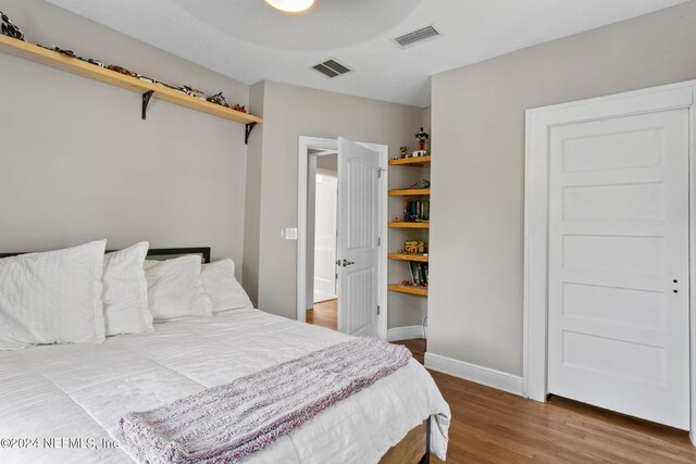 bedroom with ceiling fan and hardwood / wood-style flooring