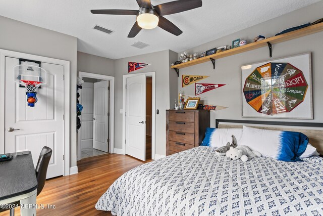 bedroom with ceiling fan and wood-type flooring