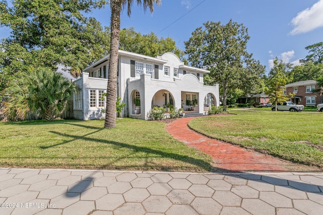 mediterranean / spanish house with a front yard