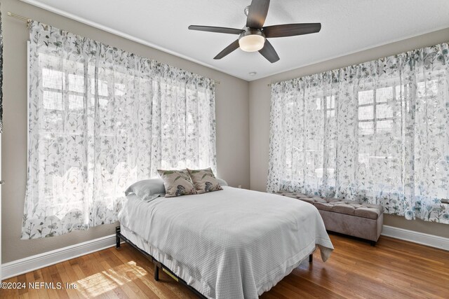 bedroom with ceiling fan and wood-type flooring