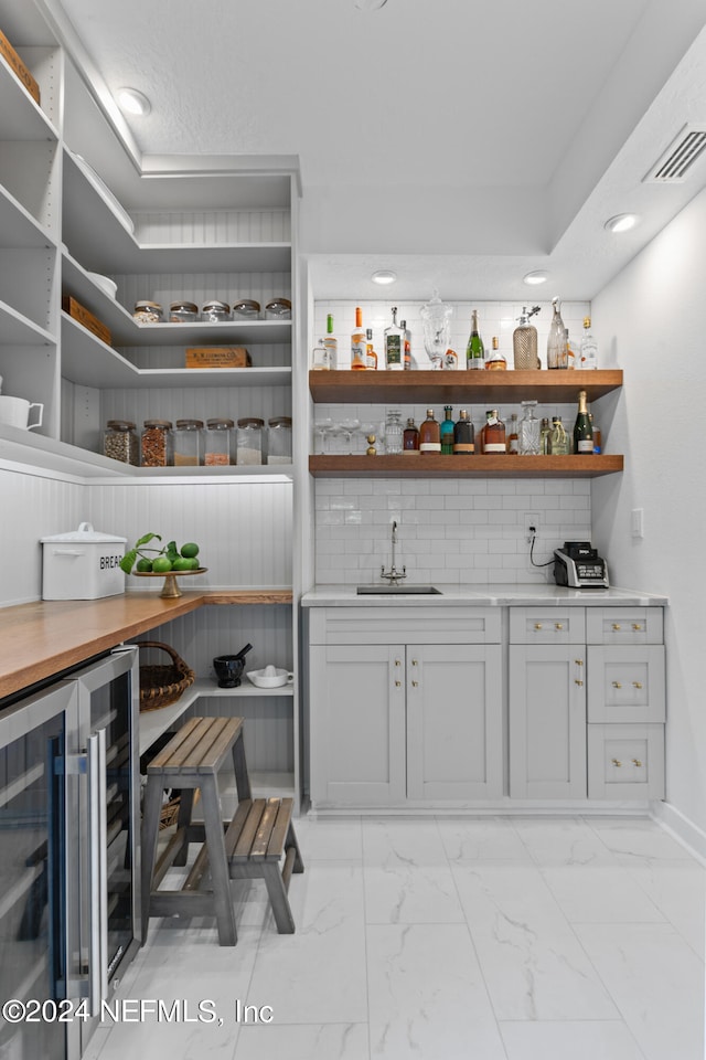 pantry with sink and beverage cooler